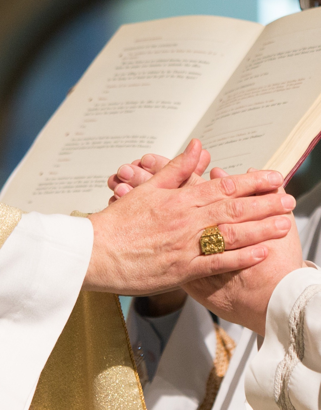 Pledge of Obedience to the Archbishop of the Diocese Picture shows candidate placing his hands in the hands of the Bishop pledging his obedience to the Archbishop and his successors